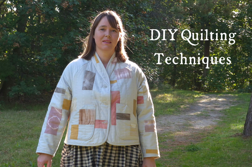 A woman walks along a dirt path among the trees, wearing a handmade Loft Quilted Jacket made from a variety of plant-dyed materials.