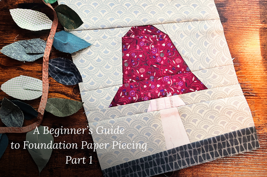 A finished Toadstool FPP Quilt Block is shown, with a scrappy fabric leaf garland draped over one side and the title "A Beginner's Guide to Foundation Paper Piecing Part 1" layered on top.