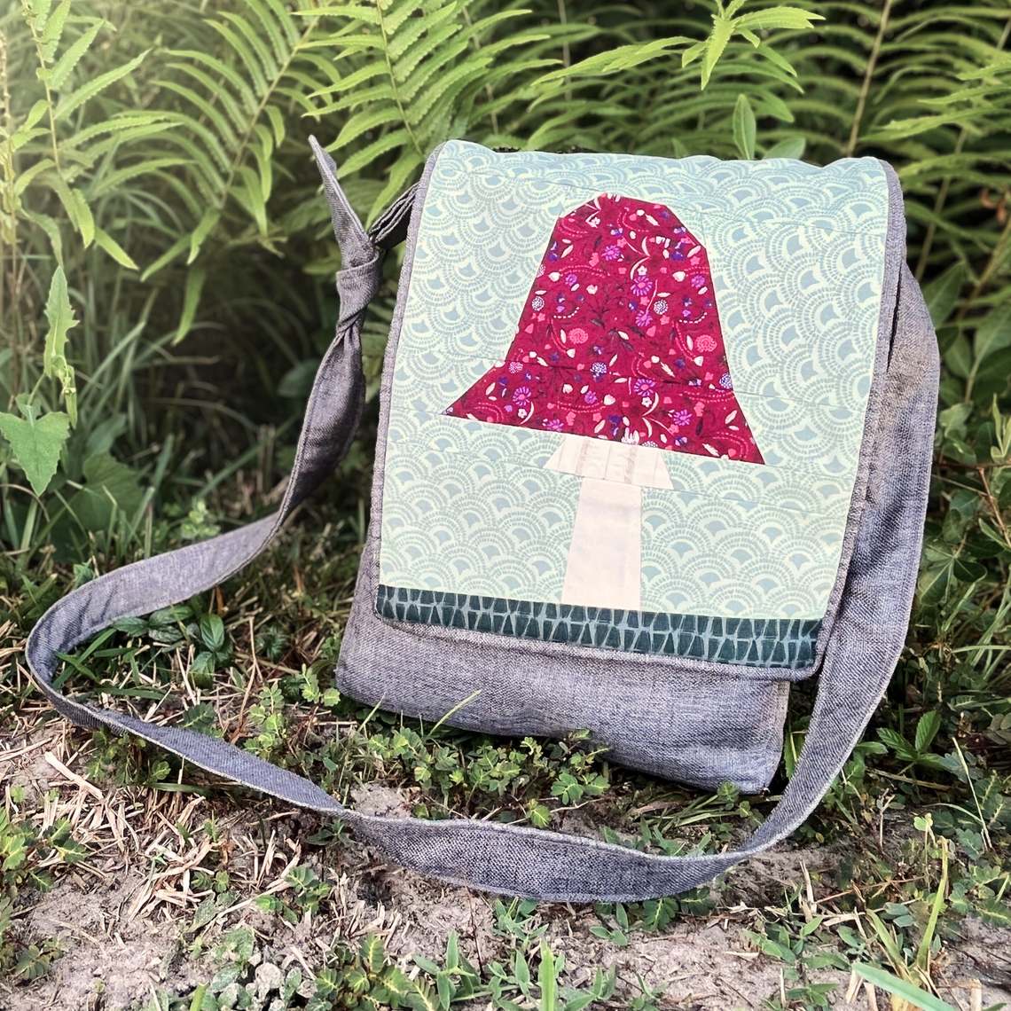 A Toadstool foundation-paper-pieced panel is featured on the front of a Foraging Satchel.