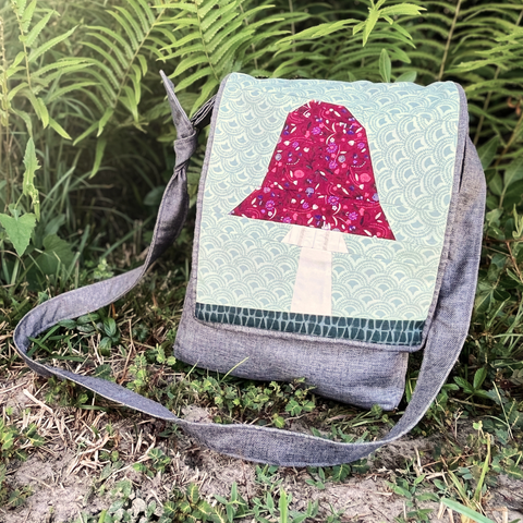 A Toadstool foundation-paper-pieced panel is featured on the front of a Foraging Satchel.